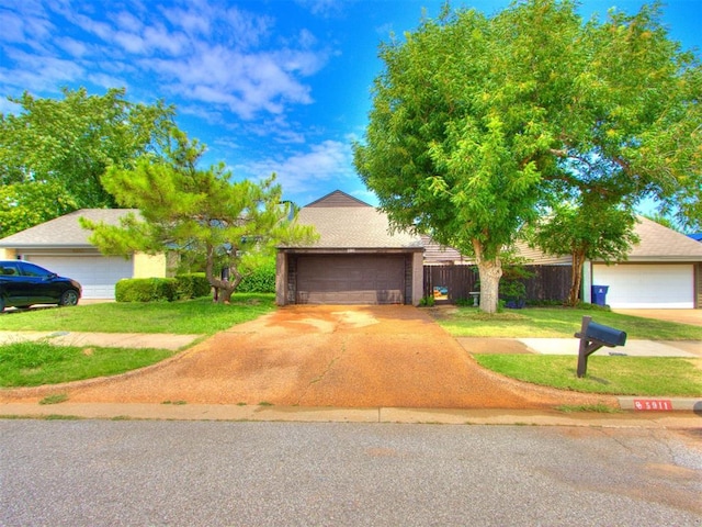 view of front facade featuring a front yard and a garage