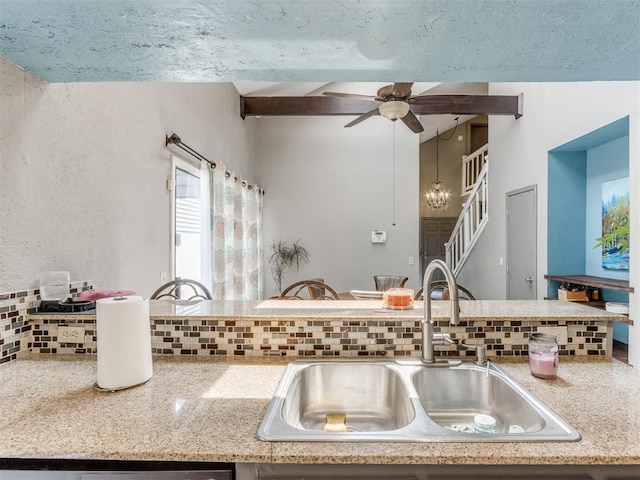 kitchen with decorative backsplash, sink, and ceiling fan