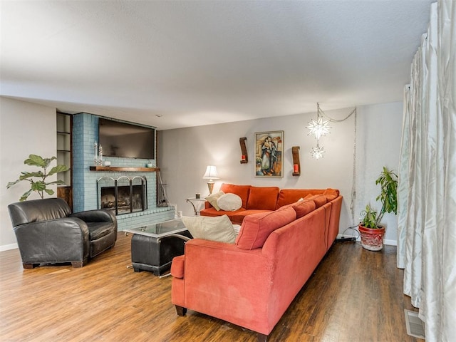 living room with wood-type flooring and a fireplace