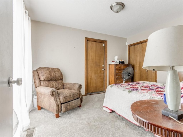 bedroom featuring light carpet and a closet