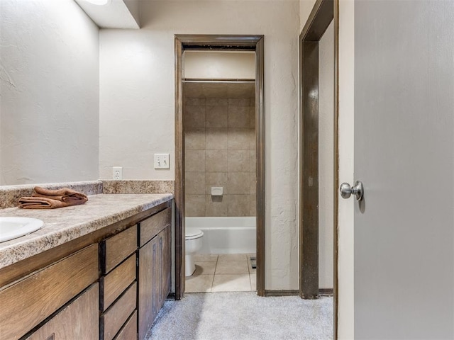 bathroom featuring tile patterned floors, vanity, and toilet