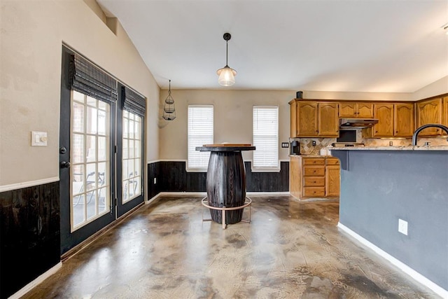 kitchen featuring lofted ceiling, sink, and hanging light fixtures