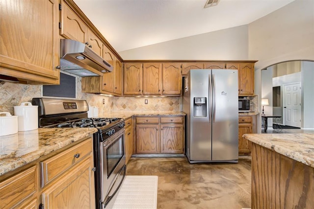 kitchen with tasteful backsplash, lofted ceiling, stainless steel appliances, and light stone countertops