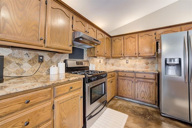 kitchen featuring lofted ceiling, light stone countertops, tasteful backsplash, and stainless steel appliances