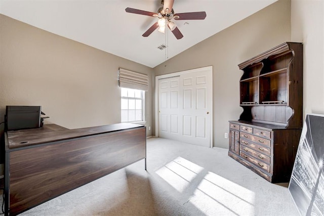 carpeted bedroom with ceiling fan, lofted ceiling, and a closet