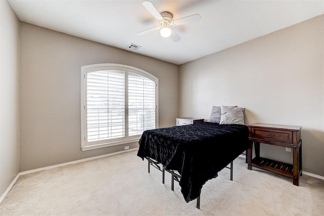 bedroom with ceiling fan and light carpet