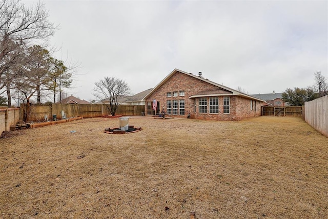 rear view of property with a yard