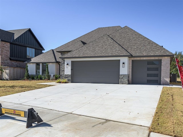 view of front facade featuring a garage and cooling unit