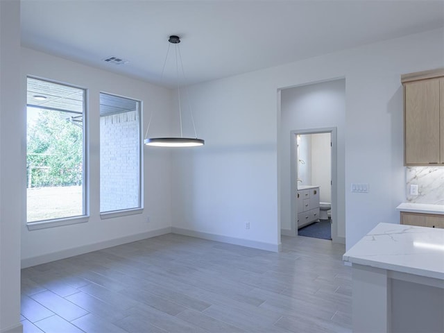 unfurnished dining area with light hardwood / wood-style floors