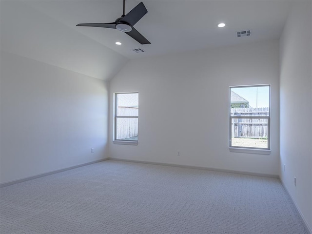 unfurnished room featuring ceiling fan, light colored carpet, and lofted ceiling