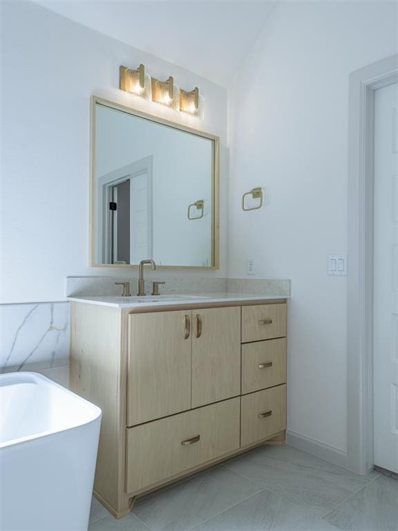 bathroom featuring vanity and a bath