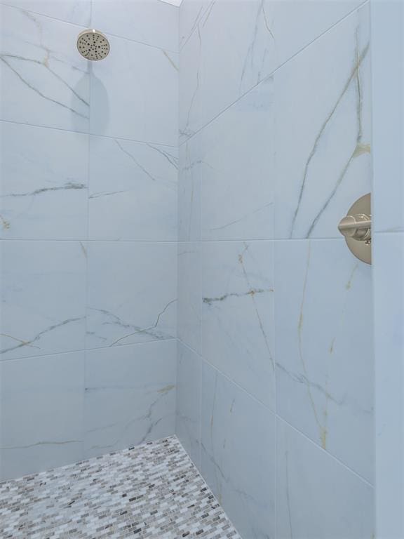 bathroom with tiled shower