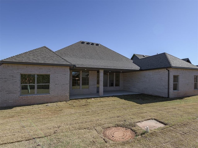 back of house featuring a yard and a patio