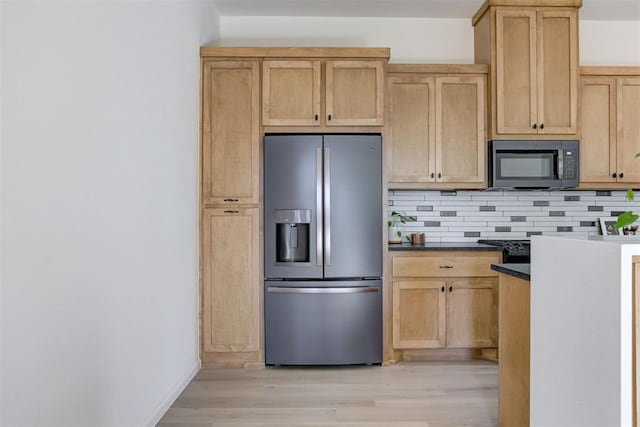 kitchen featuring tasteful backsplash, stainless steel fridge with ice dispenser, light hardwood / wood-style flooring, dark stone counters, and light brown cabinetry