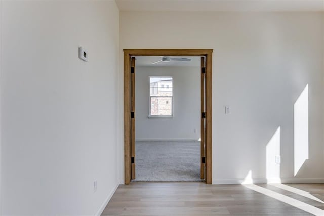 corridor with light hardwood / wood-style floors