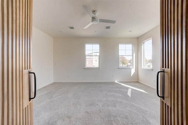 carpeted empty room with ceiling fan