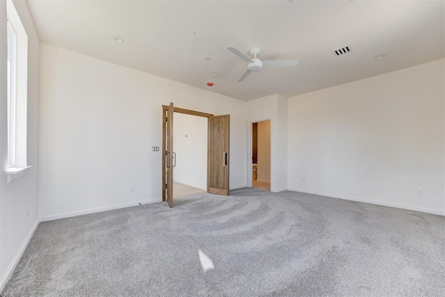 empty room with light carpet and ceiling fan