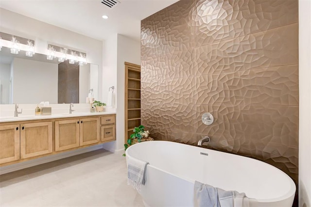 bathroom featuring a bathtub, tile walls, and vanity