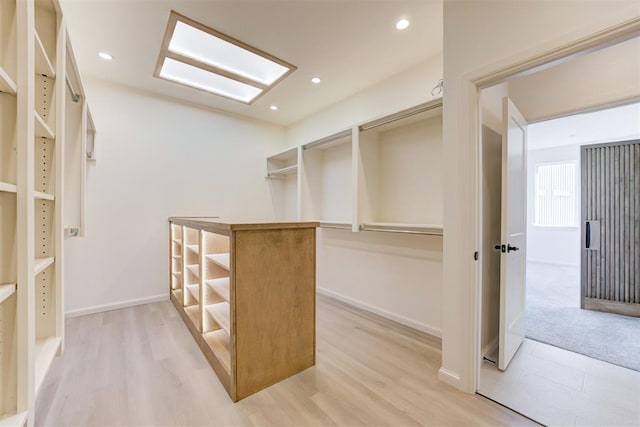 spacious closet with light hardwood / wood-style floors