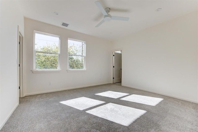 empty room with light colored carpet and ceiling fan