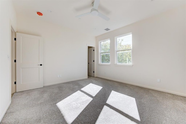 spare room with light colored carpet and ceiling fan