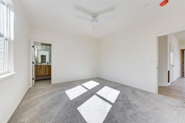 carpeted empty room featuring ceiling fan