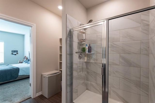 bathroom featuring wood-type flooring and walk in shower