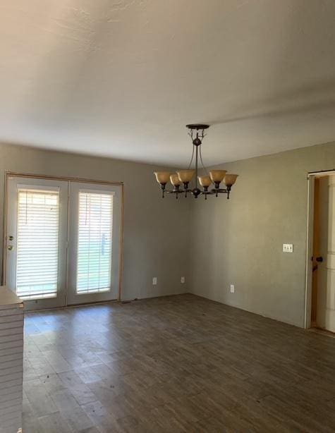 spare room featuring a chandelier