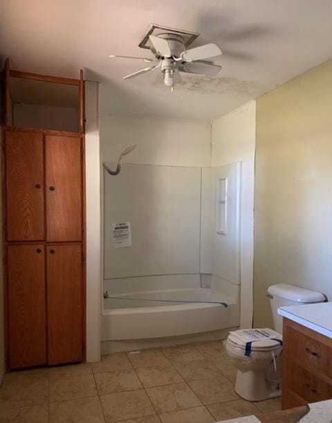 bathroom with tile patterned floors, ceiling fan, vanity, and washtub / shower combination