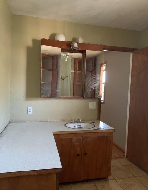 kitchen featuring light tile patterned flooring and sink