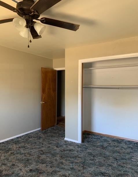 unfurnished bedroom featuring ceiling fan, a closet, and dark carpet