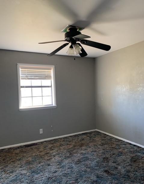 carpeted empty room with ceiling fan