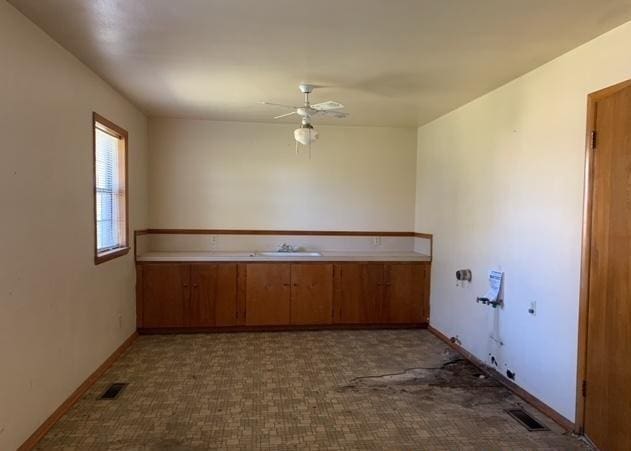 clothes washing area featuring ceiling fan and sink