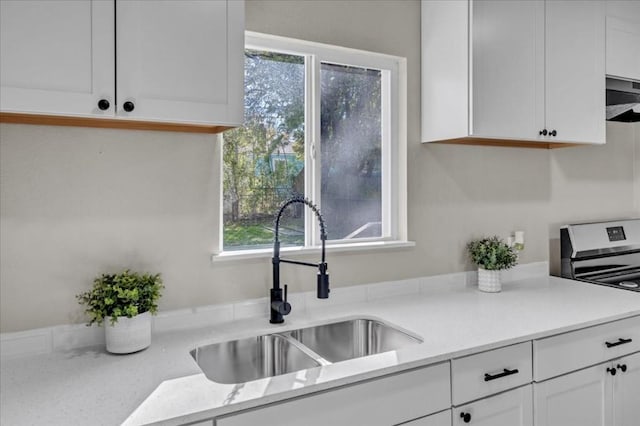 kitchen with white cabinets and a healthy amount of sunlight