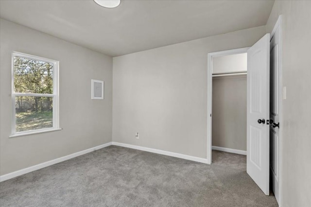 unfurnished bedroom with light carpet and a closet