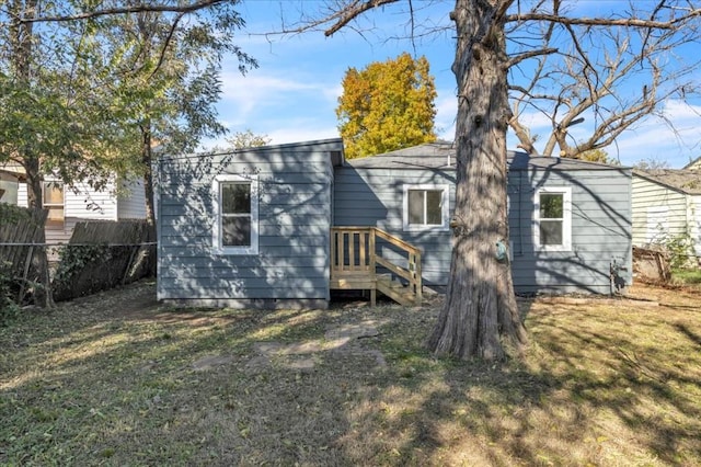 rear view of property with a yard