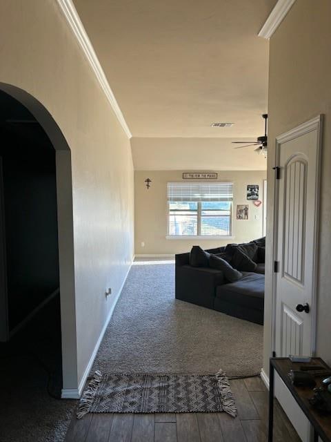 hallway with hardwood / wood-style flooring and ornamental molding