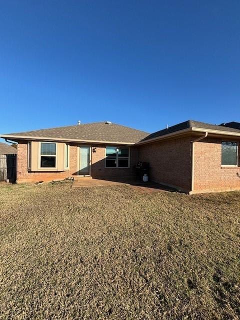 rear view of property with a yard