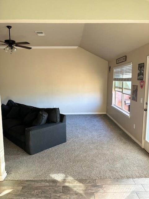 unfurnished living room with ceiling fan, light colored carpet, and vaulted ceiling