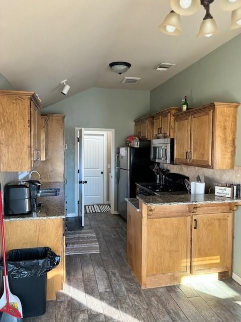 kitchen with tasteful backsplash, dark wood-type flooring, sink, black appliances, and lofted ceiling