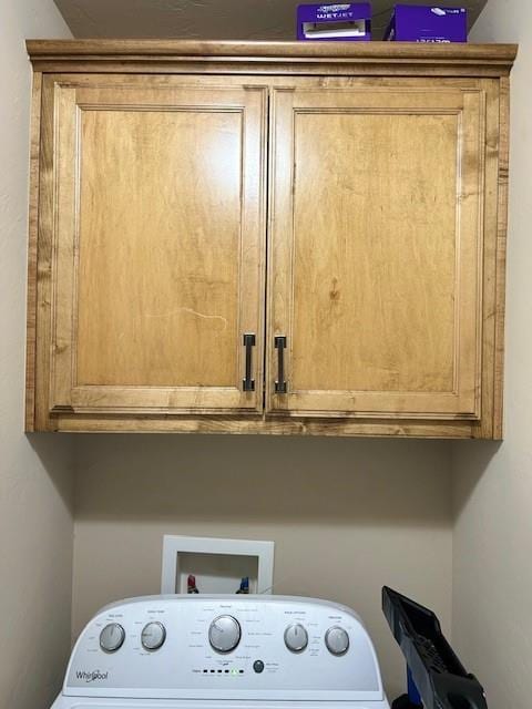 laundry room featuring cabinets