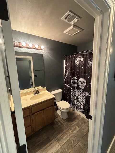 bathroom with hardwood / wood-style floors, vanity, and toilet