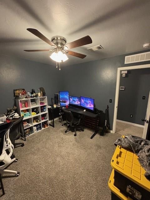 carpeted office space with ceiling fan