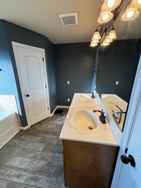 bathroom featuring a tub to relax in and vanity