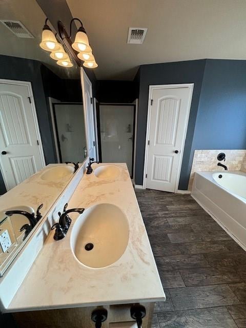 bathroom featuring separate shower and tub, hardwood / wood-style floors, and vanity