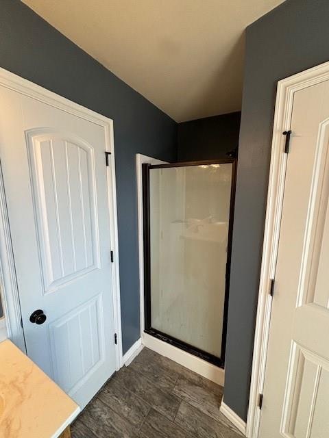 bathroom featuring wood-type flooring and walk in shower