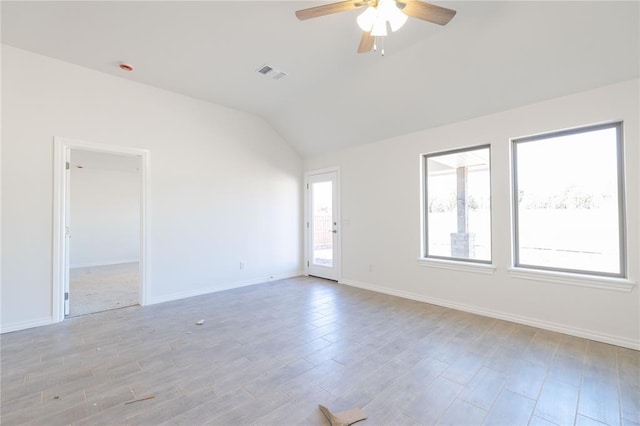 unfurnished room featuring visible vents, baseboards, light wood-type flooring, vaulted ceiling, and a ceiling fan