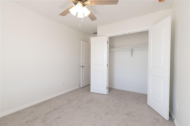 unfurnished bedroom featuring visible vents, baseboards, carpet floors, ceiling fan, and a closet