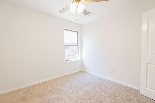 unfurnished room featuring a ceiling fan, light colored carpet, and baseboards