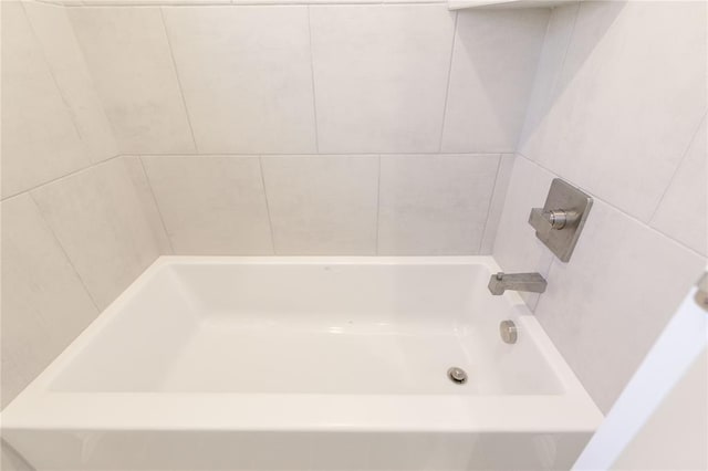 bathroom featuring a tub and walk in shower